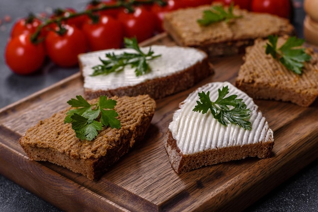 Appetizer baguette with liver paste and herbs closeup Homemade breakfast