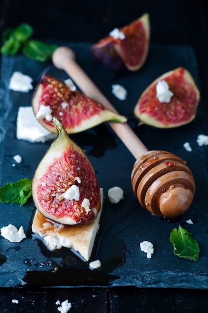 Appetizer of figs and cheese with honey.