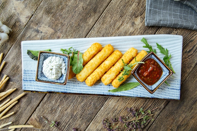 Appetizer snacks deep fried cheese sticks sauce