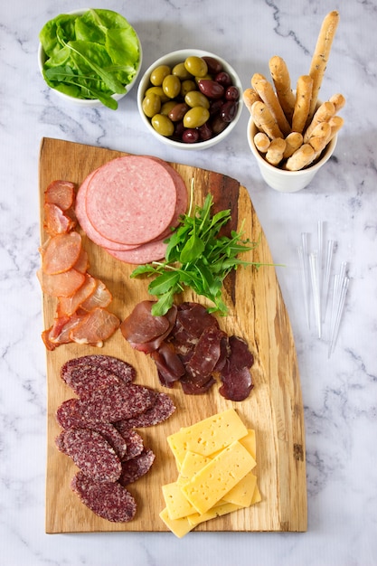 Photo appetizer table for wine or beer with sausages, dried meat and cheese