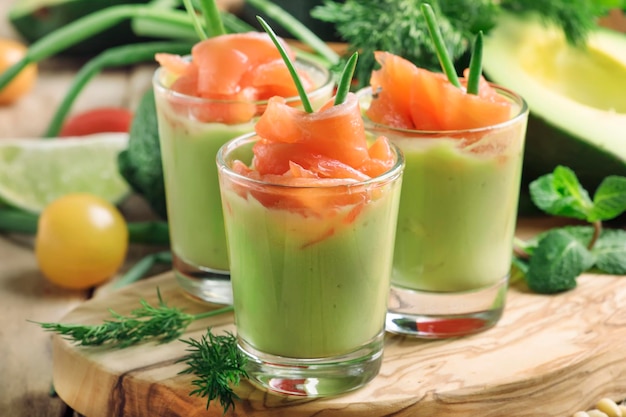 Appetizer with salted salmon and avocado cream with green onion selective focus