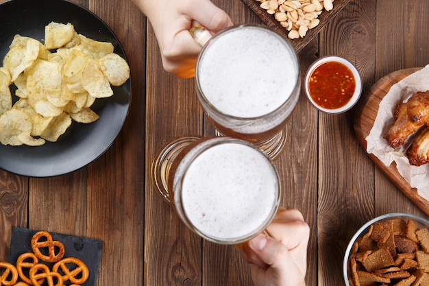 Appetizers and beer on the table for the football party and watch the football match.