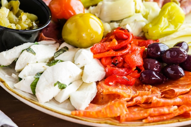 Appetizers plate with antipasto in Italian restaurant.