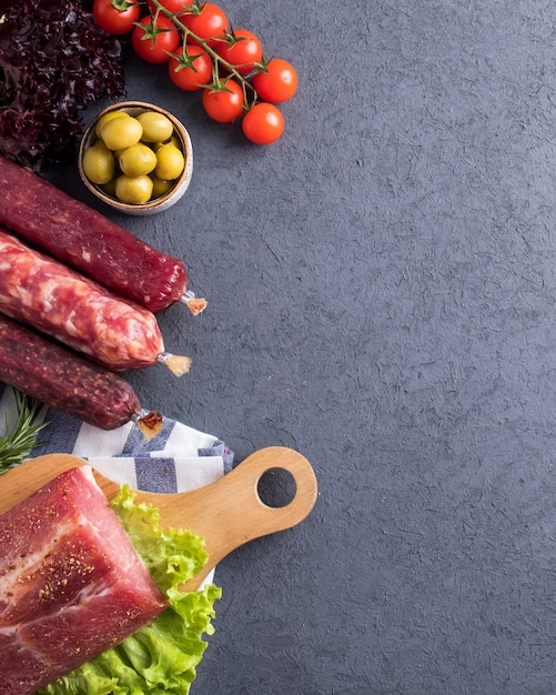 Appetizers set of salami and snacks with vegetables and spices Top view Space for text