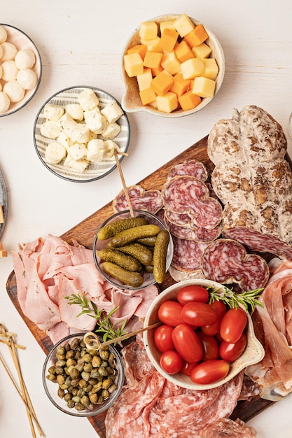 Appetizers table with different antipasti charcuterie snacks cheese