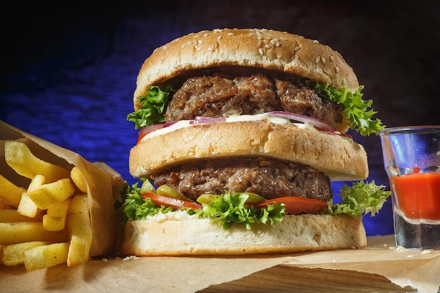 Appetizing burger on a dark background