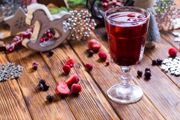 Appetizing drink with strawberries and other berries on the table