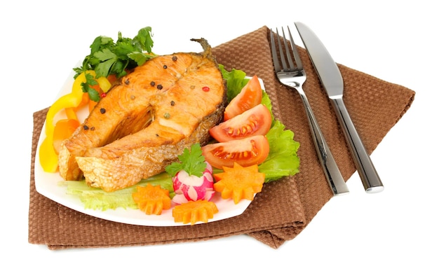 Appetizing grilled salmon with lemon and vegetables isolated on white