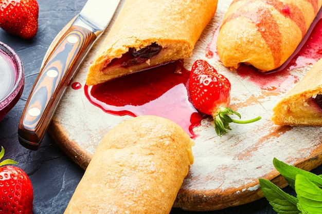 Appetizing homemade pies with strawberries and jam