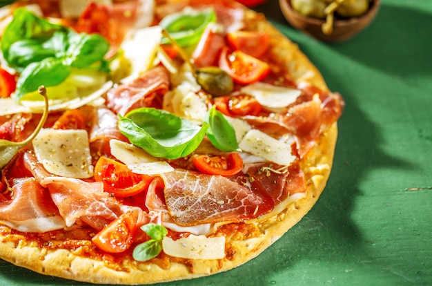 Appetizing italian pizza with prosciutto