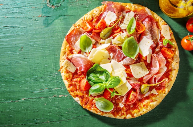 Appetizing italian pizza with prosciutto