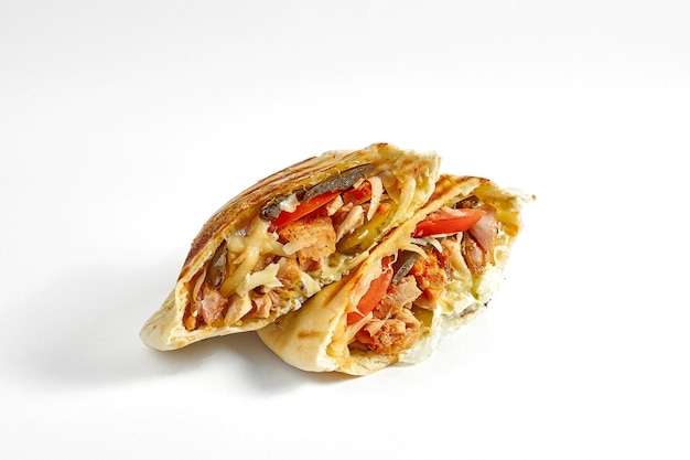 Appetizing pita with jalapeno peppers red sauce vegetables and meat isolated on a white background