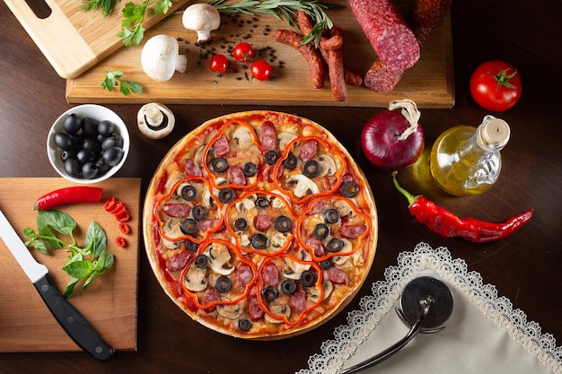 Appetizing pizza on a dark table with ingredients