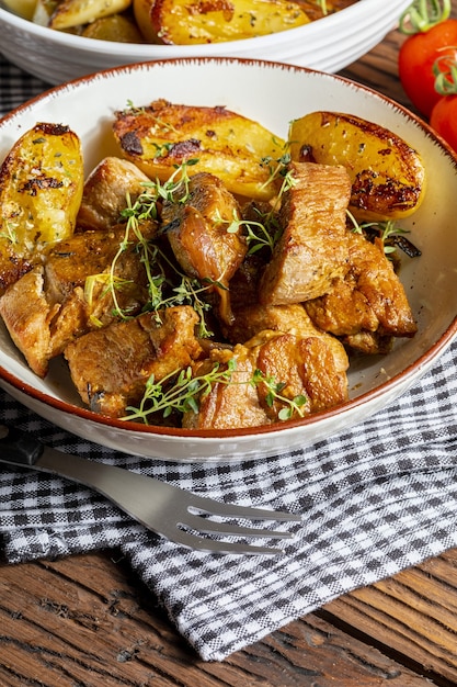 Appetizing stew of pork tenderloin meat cooked in the wok cut into cubes With roasted and golden potatoes Homemade look