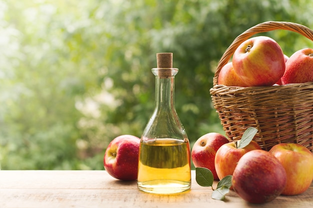 Apple cider vinegar in bottle with apple summer day