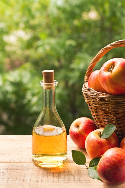 Apple cider vinegar in bottle with apple summer day