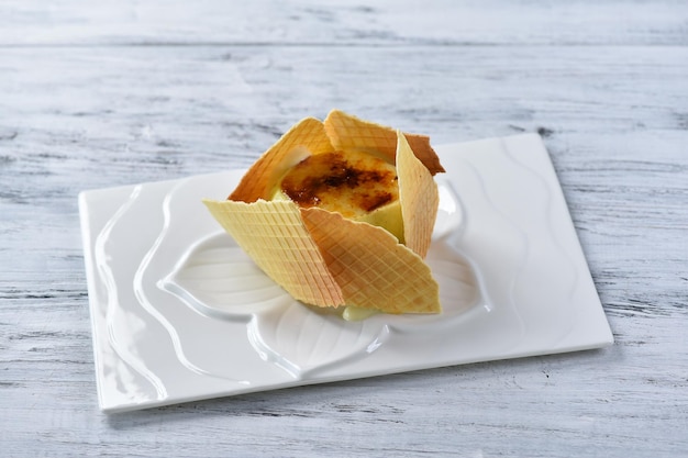 Apple ice cream creme brulee with waffles on a gray table. Background for the menu. top view