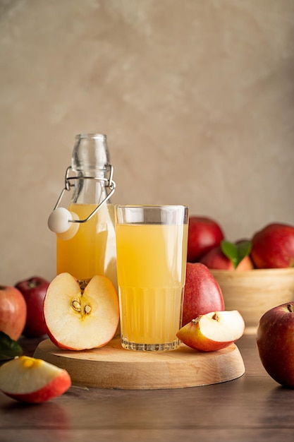 Apple juice drink with fresh red apples wooden background