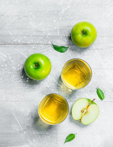 Apple juice in a glass Cup with fresh apples