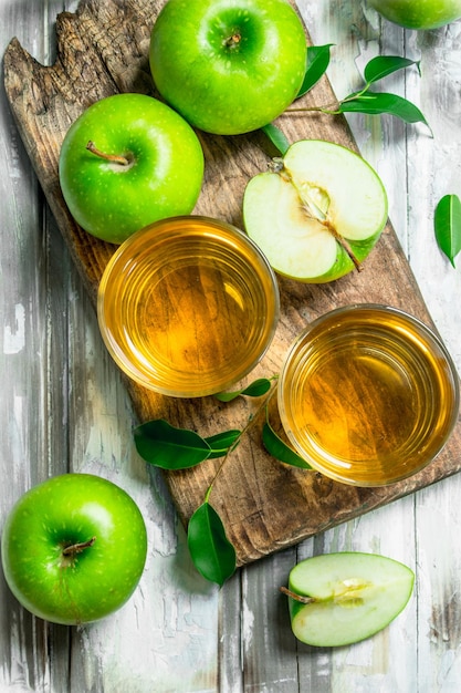 Apple juice in a glass Cup on a wooden Board