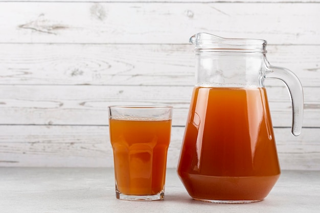 Apple juice and red apples on the table.