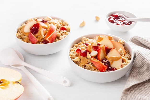 Apple peanut butter quinoa bowl with jam and cashew for healthy breakfast