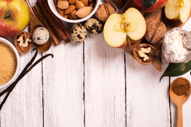 Apple pie ingrediens over white wooden