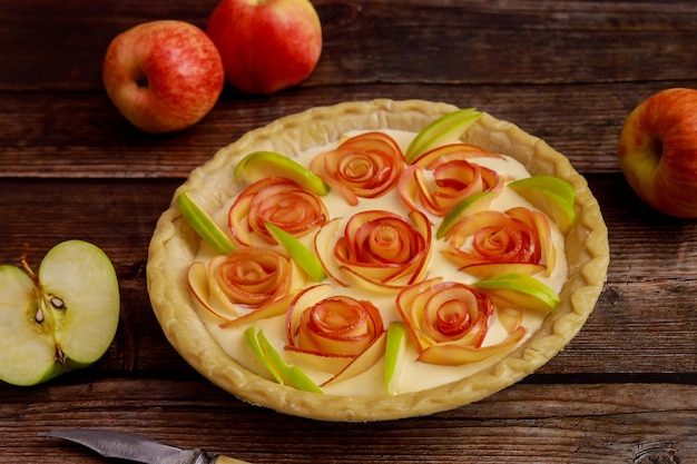 Apple pie rose shape on rustic wooden background