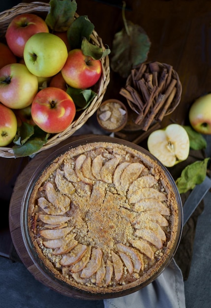 Apple pie with fresh fruits on a wooden table