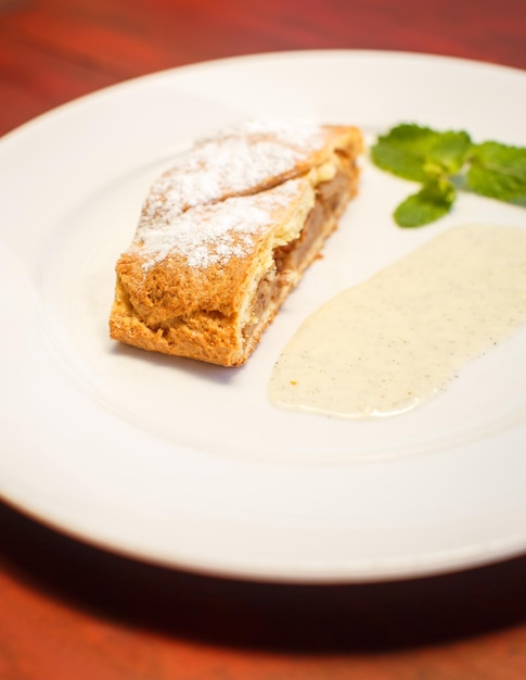 Apple strudel with sauce and coffee