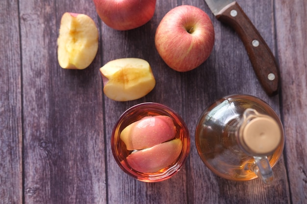 Apple vinegar in glass with fresh apple on table  top view