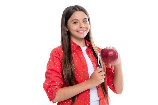 Apple vitamins for healthy teeth Teenage girl brushing her teeth Teen holds a toothbrush in hand brushing her teeth morning routine dental hygiene teeth care