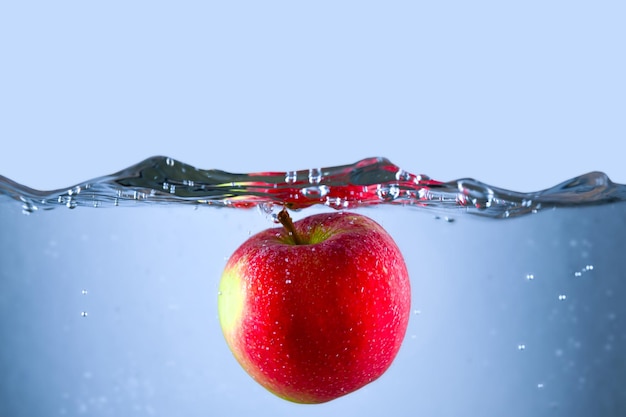 Apple in water with bubbles and the word apple