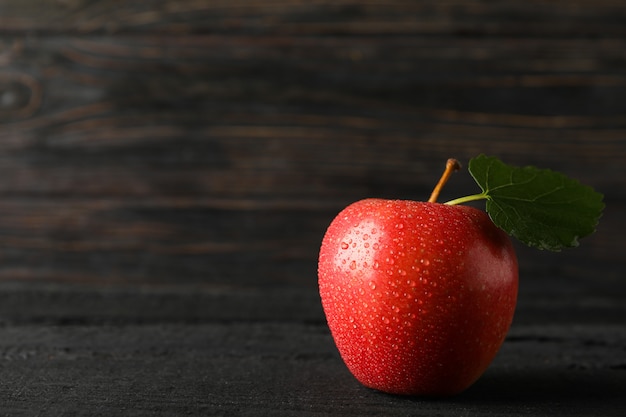 Apple with leaf on wooden table