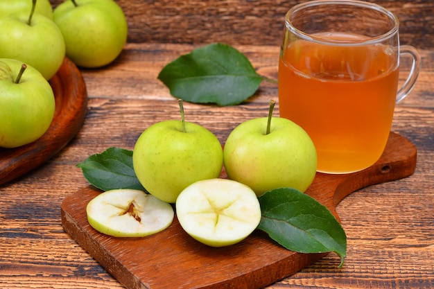 Apples and apple juice on wooden background