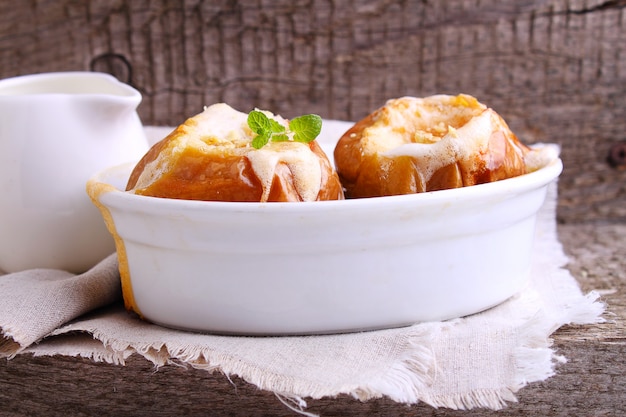 Apples baked with nuts and honey in a white ceramic form