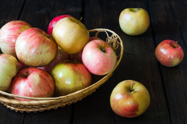 Apples in a basket on a black background