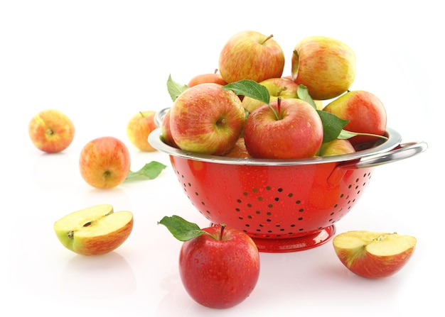 Apples in colander isolated on white