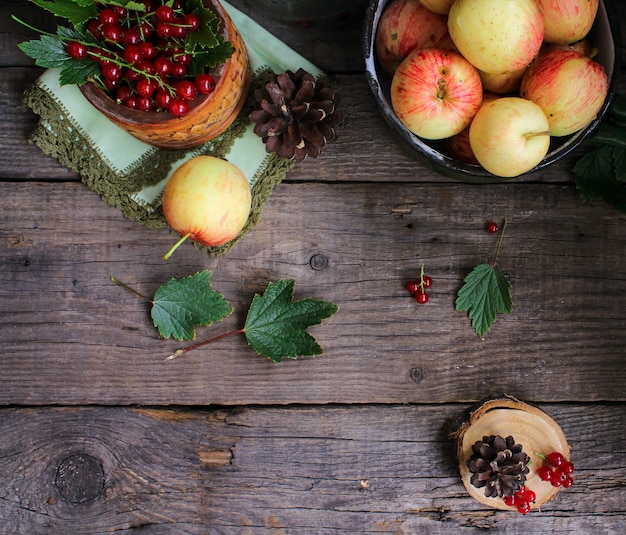 Apples currant wooden background