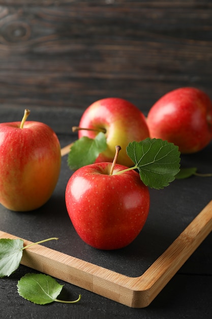 Apples and cutting board on wooden table