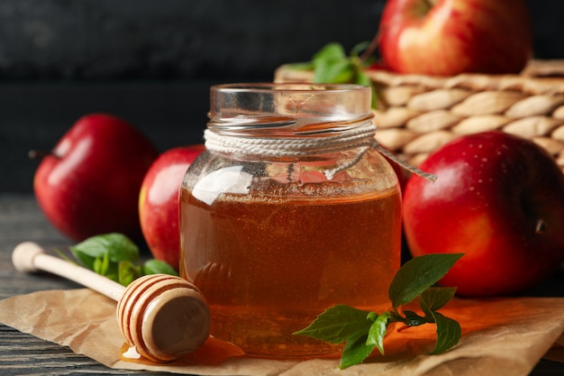 Apples and honey on wooden, close up