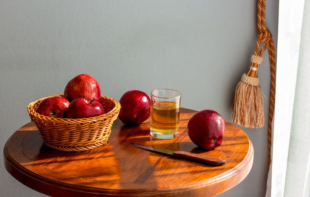 Apples on the table,apple juice,Morning in the room next to the window.