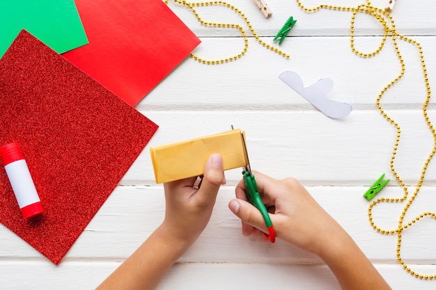 Application for kids. Christmas or New year card with gingerbread man from paper. DIY.