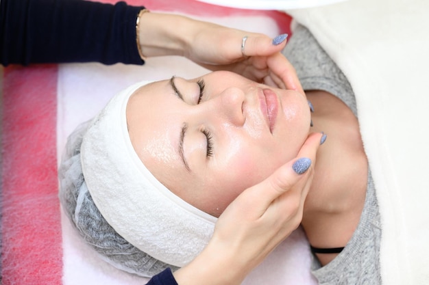 Applying cream and rubbing into the skin cosmetology relaxing procedure