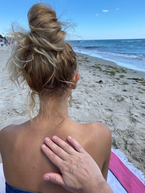 Applying sunscreen on the beach close up