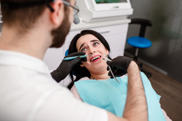 Appointment at the doctor's dentist the girl treats her teeth at the doctor's man