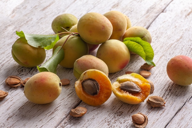 Apricot fruit. Fresh organic apricots on a white wooden table. Vega food.