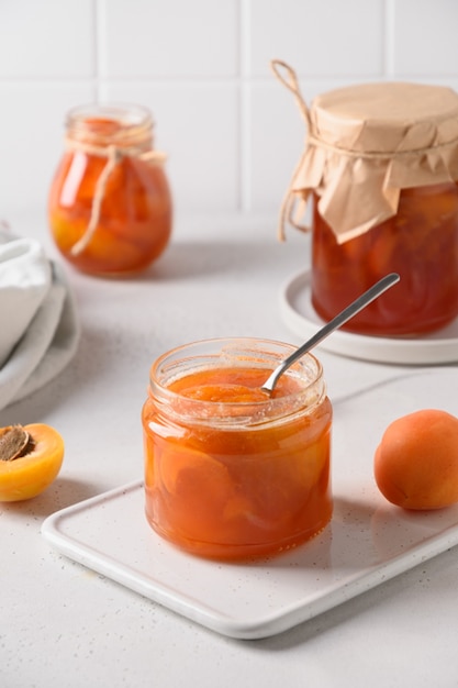 Apricot jam in glass jar with fruits summer harvest and canned food