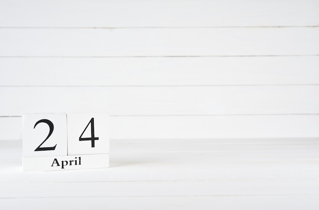 April 24th, Day 24 of month, Birthday, Anniversary, wooden block calendar on white wooden background with copy space for text.