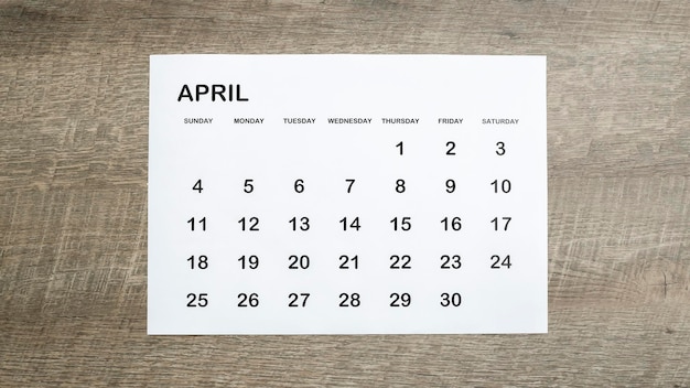 April calendar on a brown wooden table concept planner